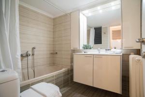 a bathroom with a tub and a sink and a shower at Beachfront ZEN sea view apartment in Itea +26 photos