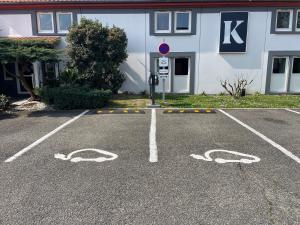 a parking lot in front of a building at Kyriad Bordeaux Lormont in Lormont