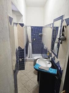 a blue and white bathroom with a sink and a shower at Casa Pellegrino in Solità +34 photos