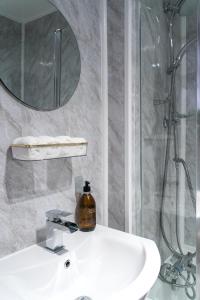 a bathroom with a white sink and a shower at Luxury seaside getaway Whitley Bay in Whitley Bay