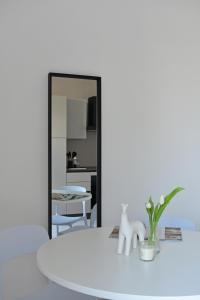a room with a mirror and a table with a plant at Poggio Al Lago Apartments & Rooms in Sirmione +43 photos