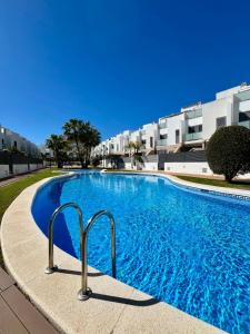 una grande piscina di fronte a un edificio di La Caleta Alcossebre a Alcalá de Chivert