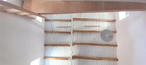 a room with wooden shelves on the wall at Solitude Studio - Serifos Chora in Serifos Chora