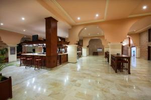 a lobby with tables and chairs in a building at Occidental Caribe - All Inclusive in Punta Cana