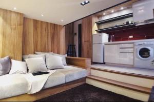 a living room with a couch and a kitchen at BV Taipei XinYi D in Taipei