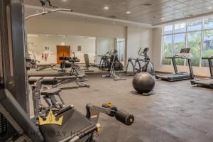 a gym with several tread machines and a mirror at Dunya tower suite 2 in Dubai