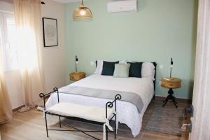 a bedroom with a bed and a chair in it at Finca Avellaneda in Navahondilla +24 photos