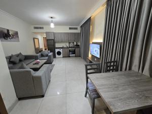 a living room with a couch and a table at Gardens Complex in Amman +38 photos