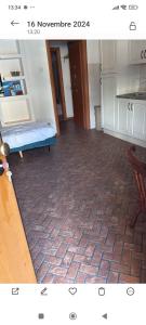 a view of a kitchen with a brick floor at La Suite in Gravellona Toce