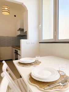 a kitchen with two plates on a table at Mare e Relax - A due passi dalla spiaggia in Spotorno
