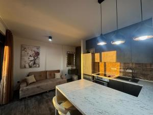 a kitchen and living room with a table and a couch at Golden Sunset 3 in Njivice