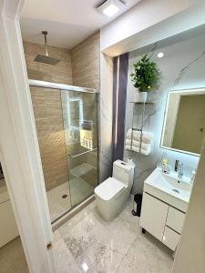 a bathroom with a shower and a toilet and a sink at Modern and cozy room in North Miami Beach