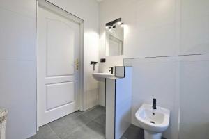 a white bathroom with a sink and a toilet at Słoneczny Dom in Poddąbie +35 photos