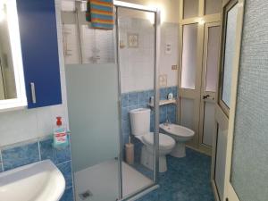 a bathroom with a toilet and a glass shower at Risorgimento House in Catania +33 photos