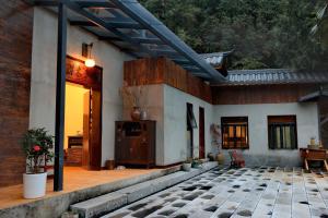 a porch of a house with a patio at Nanshe MuXi Heritage Inn in Zhangjiajie