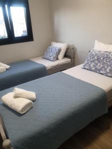 a room with two beds and a couch at Katerina Beach House in Vergia