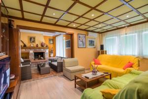 a living room with a yellow couch and a fireplace at Villa Steffani in Labin