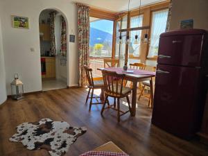 a kitchen and dining room with a table and a refrigerator at Landhaus Eibelesee in Oberstaufen +60 photos