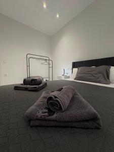 a bedroom with a bed with a towel on it at Αικατερίνα in Kozani