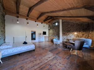 a bedroom with a bed and a living room at La Maisonnette in Présailles