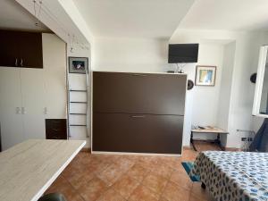 a kitchen with a large brown refrigerator in a room at Piccola Navetta in Diano San Pietro