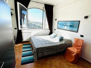 a small bedroom with a bed and a window at Piccola Navetta in Diano San Pietro