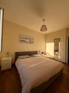 a bedroom with a large bed in a room at La casa di Eli in Genoa