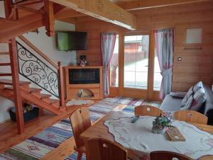 sala de estar con mesa de comedor y escalera en Domek do wynajęcia - Podczerwone, en Koniówka