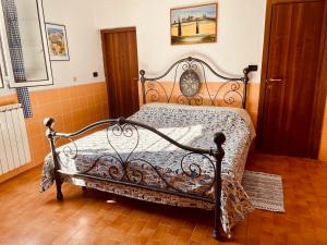 a bedroom with an iron bed in a room at Casa Uliveto in Diano San Pietro +37 photos