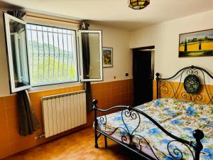 a bedroom with a bed and a window at Casa Uliveto in Diano San Pietro