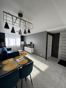 a living room with a table and a couch at Apartments in Šiauliai city center in Šiauliai