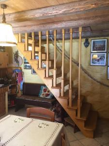 a wooden staircase in a room with a table at La Casetta sulla Marteniga in Trichiana +11 photos