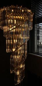 a chandelier with many wine glasses in a room at Apartament Gwiazda Renesansu in Zamość