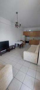 a living room with two couches and a table at Areopoli Apartment 7 in Areopolis