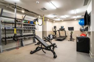 a gym with exercise equipment in a room at Hala DC in Washington +7 photos