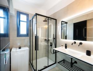 a bathroom with a shower and a sink at A L'AISE STUDIOs in Apolpaina +21 photos