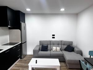 a living room with a couch and a table at Casa Cuchariños Louro in Louro