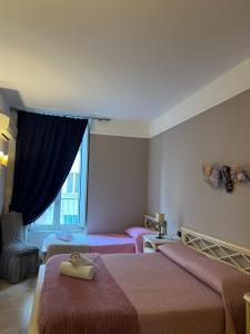 Postel nebo postele na pokoji v ubytování B&B La Dimora Di Nettuno