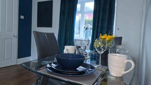 a dining room table with a bowl on top of it at Kabaka - Comfy Birley 3 Bedroom Home in Frecheville