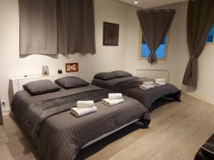 a bedroom with two beds with towels on them at Studio 6 in Le Boupère