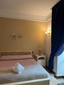 Postel nebo postele na pokoji v ubytování B&B La Dimora Di Nettuno
