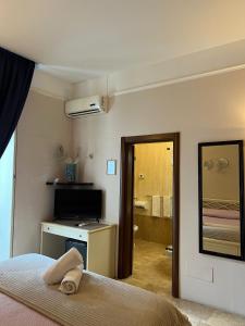 Postel nebo postele na pokoji v ubytování B&B La Dimora Di Nettuno