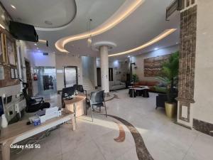 a lobby with chairs and tables in a building at بست تريب ميلانو للشقق المخدومة in Jeddah