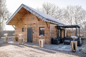 a log cabin with a porch and a patio at Love-Room BreakyWell in Rémelfang