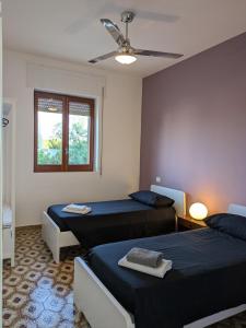 Ένα ή περισσότερα κρεβάτια σε δωμάτιο στο Villa Bruno, la tua casa in riva al mare