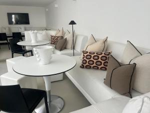 a living room with a couch and tables and pillows at Seaside in Portrush