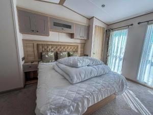 une chambre avec un grand lit avec des draps blancs dans l'établissement Beautiful Lodge At Manor Park In Hunstanton Ref 23018K, à Hunstanton 15 autres photos