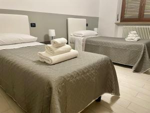 Ένα ή περισσότερα κρεβάτια σε δωμάτιο στο Domus Pellicciai