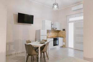 a kitchen with a table and chairs in a room at Alderi's Room in Termoli