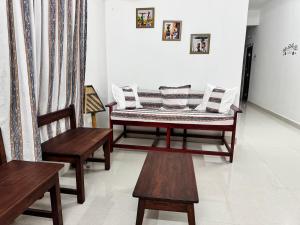 a bench with pillows on it in a room at Kelly cottages in Warangal